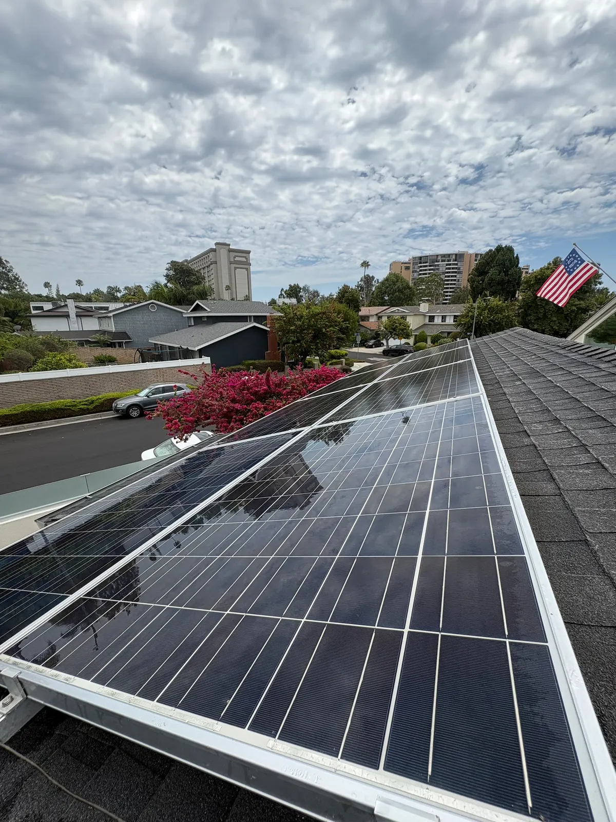 A freshly cleaned rooftop solar array overlooking the neighborhood