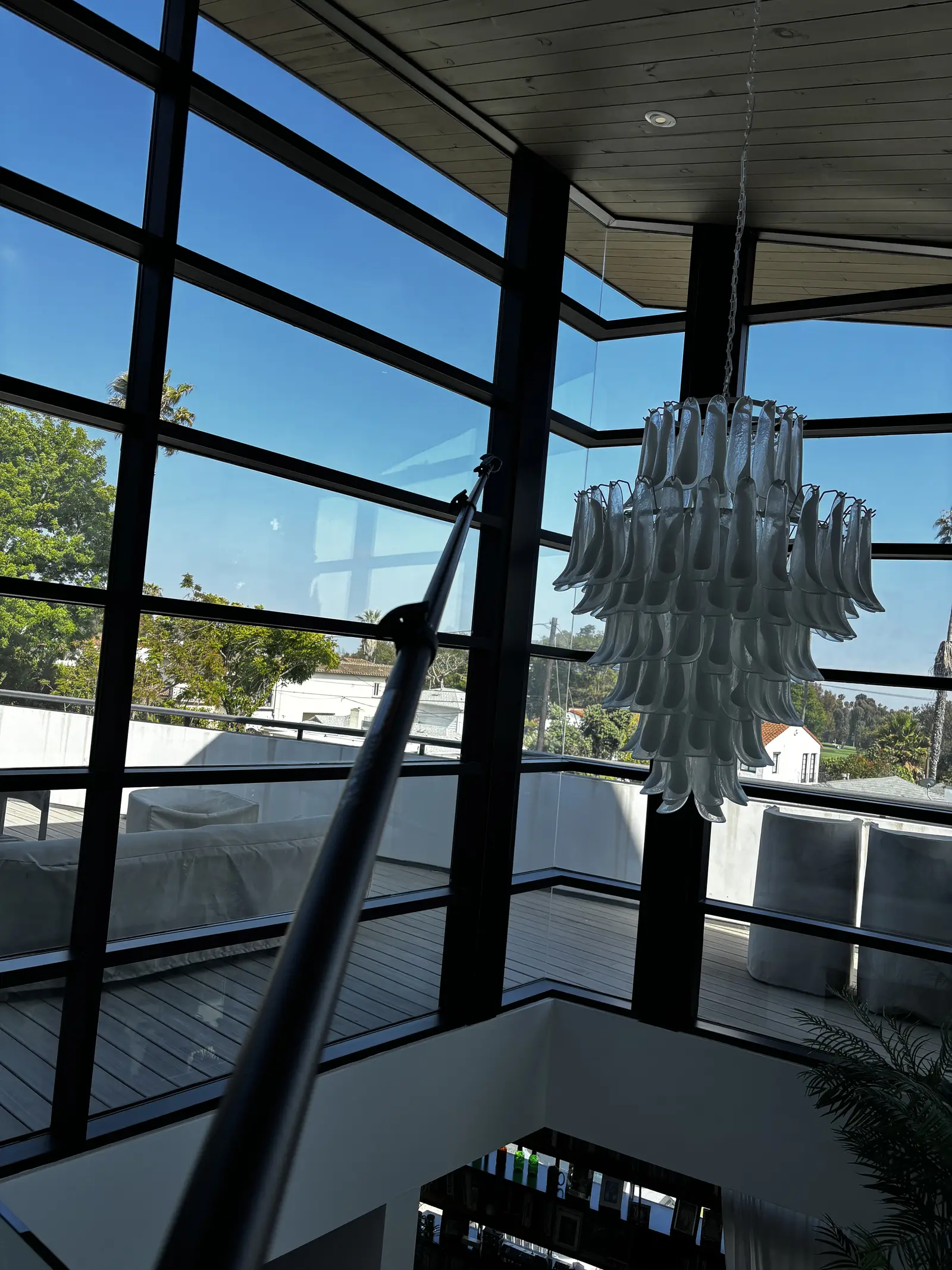 Floor-to-ceiling clean glass and chandelier