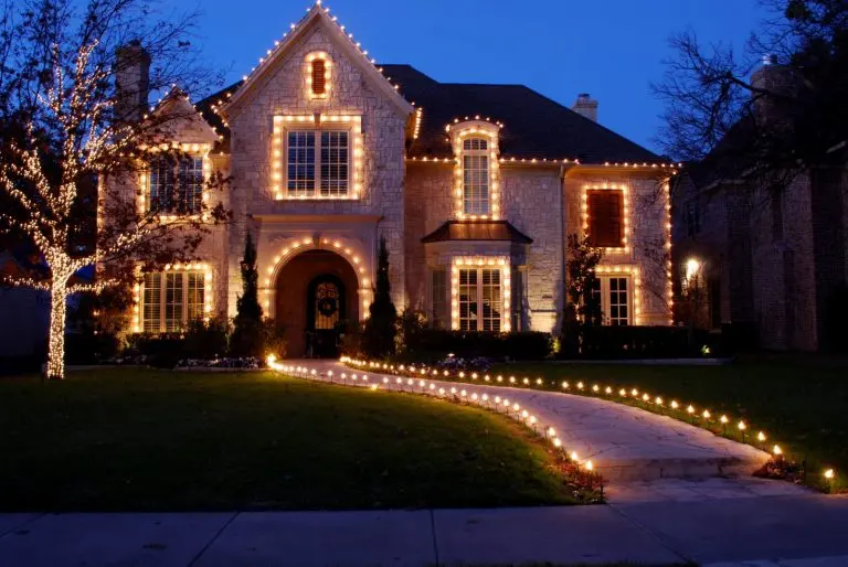 A home with lit rooflines and a lit walkway
