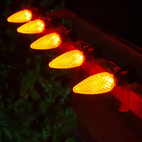 Orange lights installed along a roofline