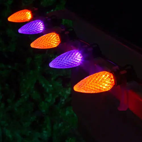 Purple and orange bulbs alternating on a roofline