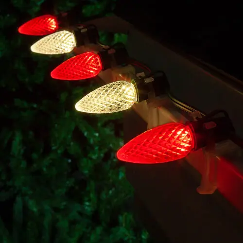 Warm white and red bulbs alternating on a roofline